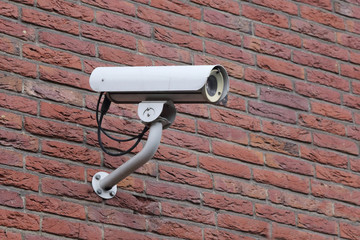 security camera on the brick wall