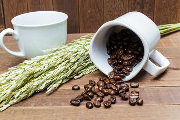 Coffee beans in coffee cup on wooden background