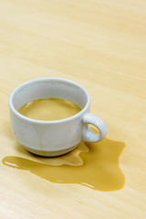 Cup of coffee spill on desk