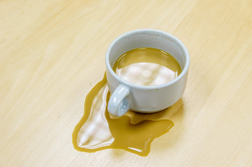 Cup of coffee spill on desk