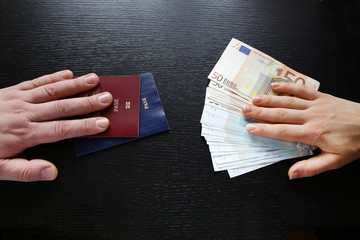 buying illegal foreign passport hands exchanging money and docum