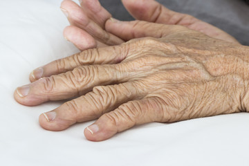 Fototapeta premium Old hands on the bed
