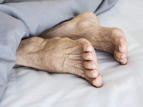 Old feet on the bed