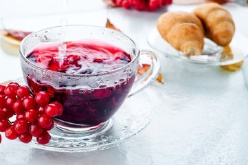 Red berries  viburnum and cup of tea