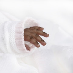 Hand of an one-month-old baby girl 