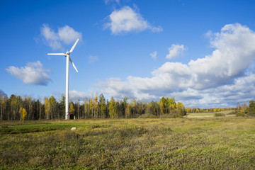 windmill for electric power production against blue sky