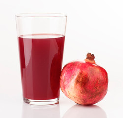 glass of juice and pieces of pomegranate
