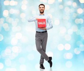 smiling man with red shopping bag