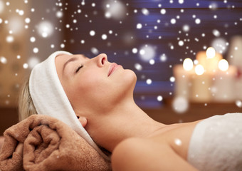 close up of smiling young woman lying in spa salon