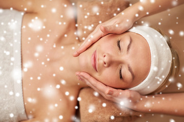 close up of woman having face massage in spa salon