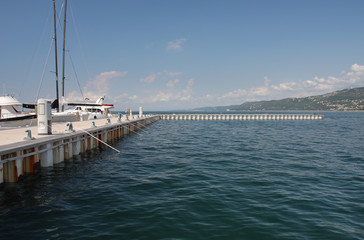 Obraz premium Pier for motor boats and sailboats in harbor in Trieste, Italy