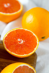 Fototapeta na wymiar red oranges on wooden surface