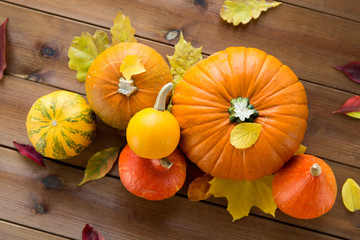 close up of pumpkins on wooden table at home