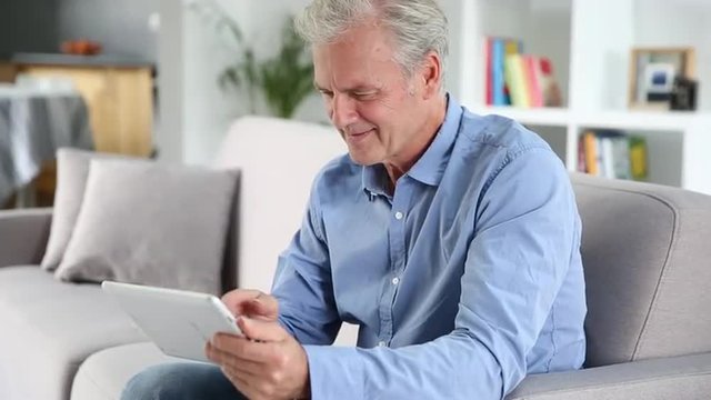 Mature man using a tablet pc