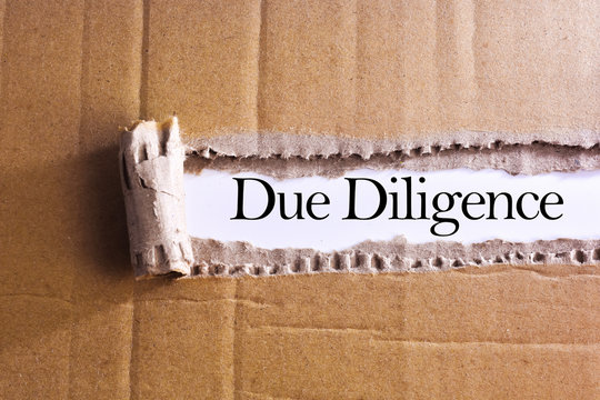 Torn paper box with word Due diligence