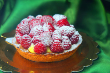 Pie covered with raspberries