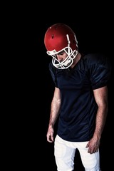 Composite image of rugby player looking down