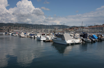 Fototapeta na wymiar Motor boats and sailboats in harbor in Trieste, Italy