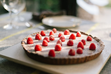 Delicious Chocolate Pie with Raspberries on top  powdered with icing sugar for Christmas dinner party