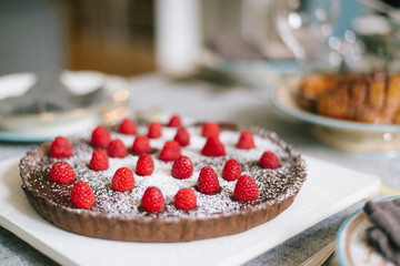 Delicious Chocolate Pie with Raspberries on top  powdered with icing sugar for Christmas dinner party
