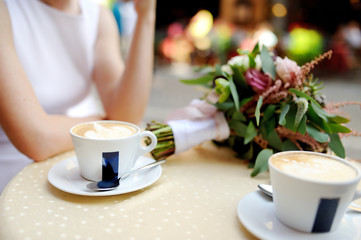 Bride and groom drinking coffee