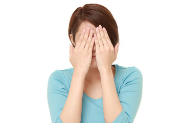 Fototapeta premium woman covering her face with hands 