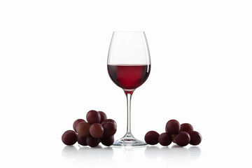 Drink and food. Wineglass, with red  wine and red grapes isolate