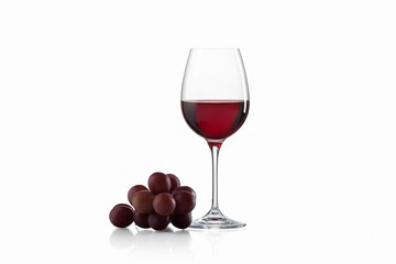 Drink and food. Wineglass, with red  wine and red grapes isolate