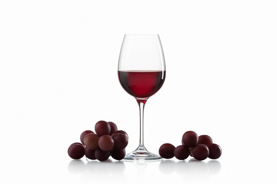 Drink And Food. Wineglass, With Red  Wine And Red Grapes Isolate