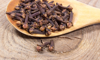 Cloves on a wood board.