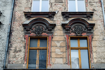 Fototapeta na wymiar Windows and facade of old building