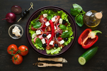 Fresh greek salad with Feta and vegetables on purple plate