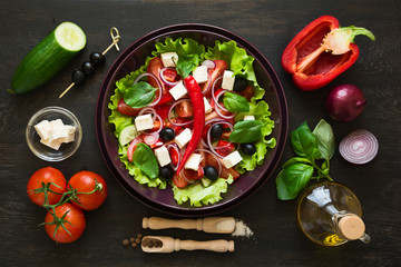 Fresh greek salad with Feta and vegetables on purple plate