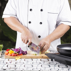 Chef cutting green cabbage