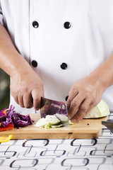 Chef cutting green cabbage