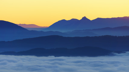 mountains with fog at sunrise