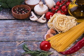 Ingredients for pasta on a wooden background