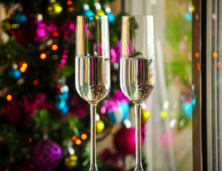 two champagner glasses on glass table with bokeh background