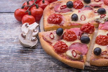 Italian pizza with mozzarella on wooden background
