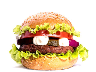 Big hamburger with beef cutlet and vegetables on white backgound