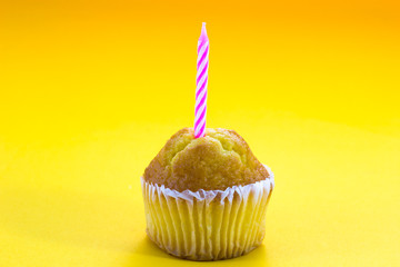 Delicious birthday cupcake on table
