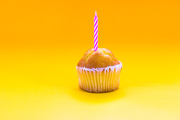 Delicious birthday cupcake on table