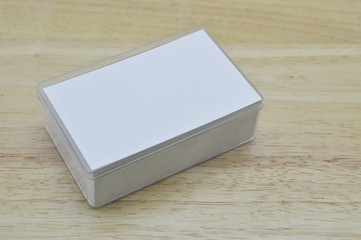 Blank business card inside box on wooden office table