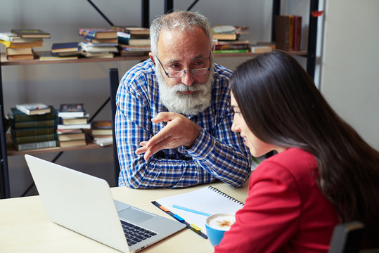 Man Explaining Something To Woman, Looking At Her