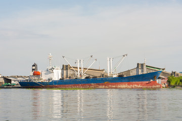 General cargo ship mooring at port wait cargo handling from indu
