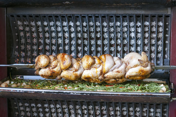 Rotisserie chicken and potatoes near the entrance of a local in Paris