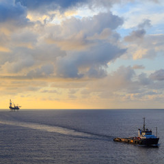Fototapeta premium Offshore jack up drilling rig and supply boat