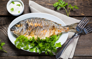 Grilled whole fish with greens