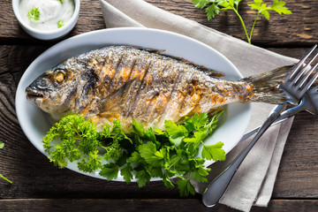 Grilled whole fish with greens