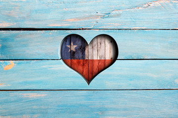 Love Chile. Heart and flag on a blue wooden board